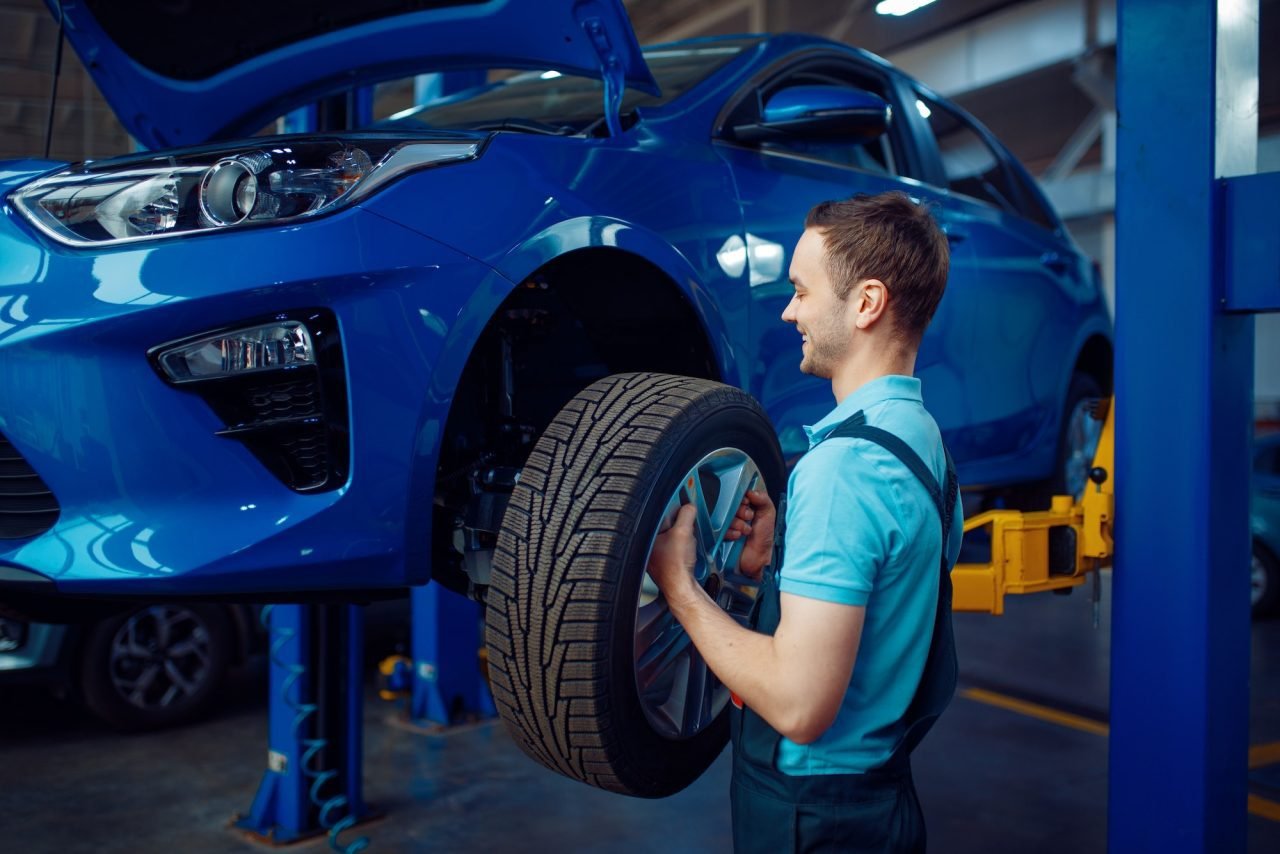 Mechanic Removing Car Wheel